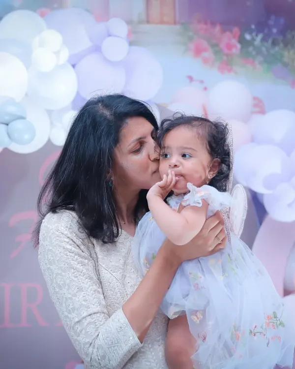 A mother's tender kiss is a memory to hold onto forever. We specialize in capturing these quiet, loving moments between a mother and her child during family celebrations.