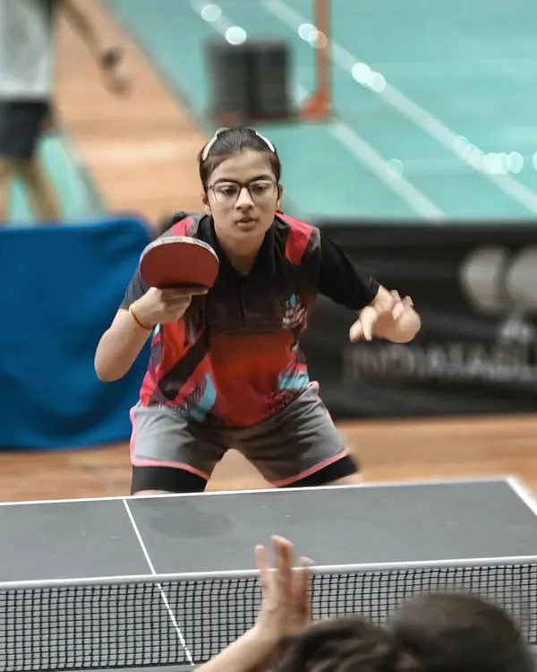 Focus in its purest form. A player executes a forehand shot during an intense rally at our academy. Every practice session is an opportunity to refine technique and build match-winning consistency.