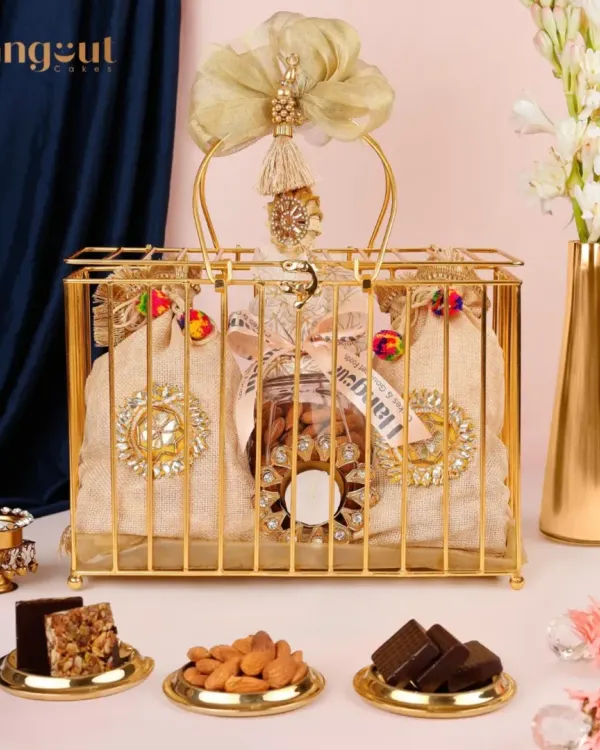 This is my Suvarna Gift Hamper, a perfect example of how I blend traditional elegance with gourmet treats. It features a beautiful golden cage holding assorted nuts and sweets, making it an ideal gift for premium festive occasions like Diwali or weddings.