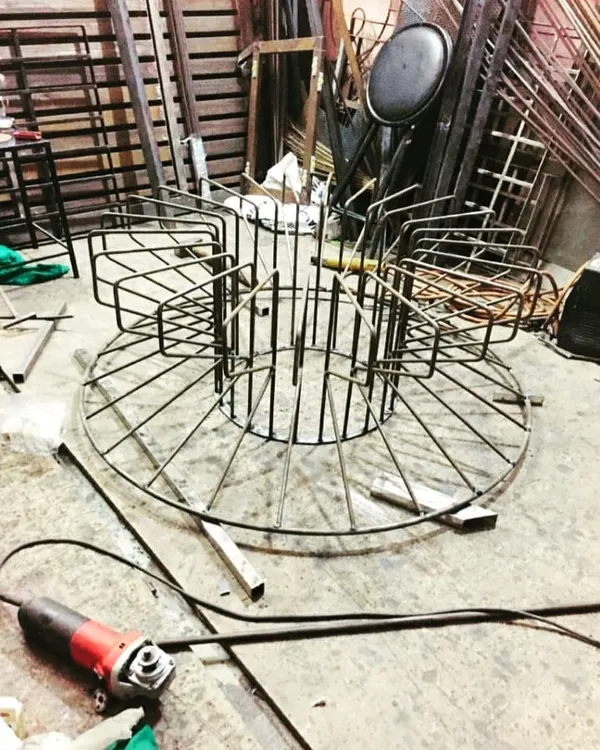 The beginning of our Bloom coffee table. Here, our team is fabricating the intricate metal base, welding each rod into place to create the signature blooming shape.