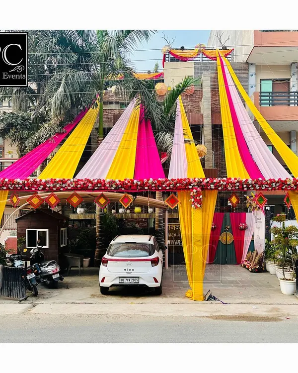 Creating that perfect 'shadi vala ghar' look. I used a canopy of bright pink and yellow drapes to create a grand tented entrance right outside the house for the wedding festivities.