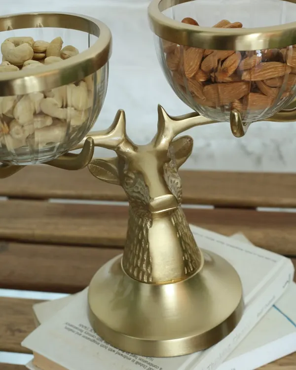 A close-up of our majestic golden reindeer bowl stand. The intricate texture of the reindeer's head and the elegant glass bowls make this a truly enchanting piece for serving snacks.