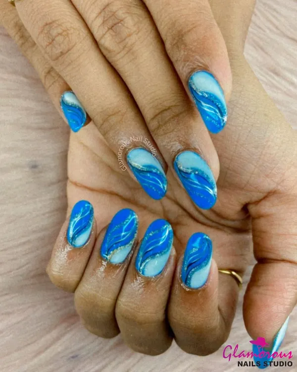Inspired by ocean waves, this mesmerizing design features swirling patterns of light and dark blue with a hint of silver glitter, creating a beautiful sense of movement.