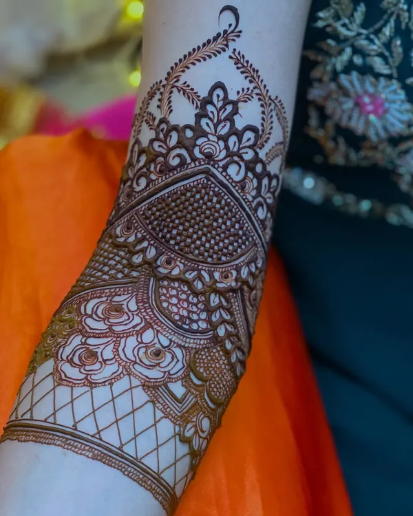A close-up of a beautiful bridal henna design, showcasing the intricate patterns on the forearm.