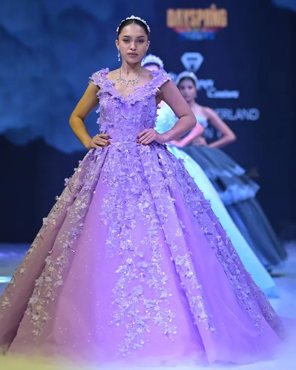 This lavender ball gown is a fairytale brought to life. From my GULFAM collection, it features layers of dreamy tulle and handcrafted 3D floral appliqués that cascade down the bodice, designed for a true queen's entrance.