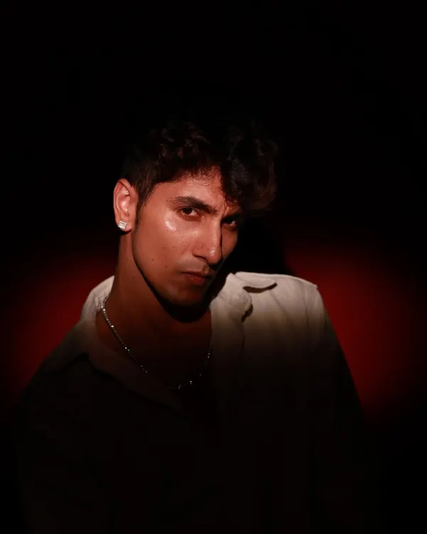 A powerful, moody portrait using dramatic side lighting to create deep shadows. This technique is great for sculpting features and creating an intense, cinematic look.