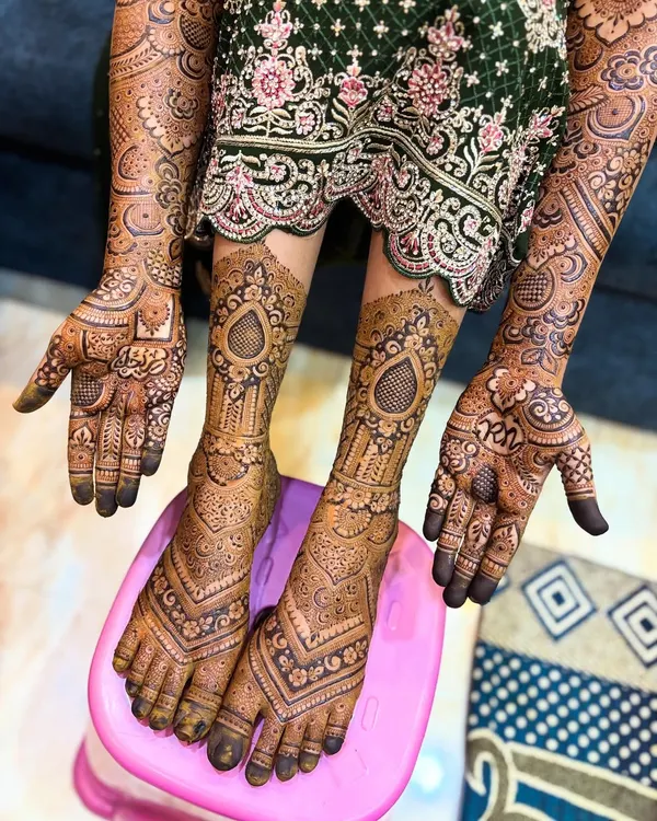 A closer look at the coordinated hand and feet mehendi. The patterns on the feet echo the geometric motifs on the hands, creating a unified bridal look.