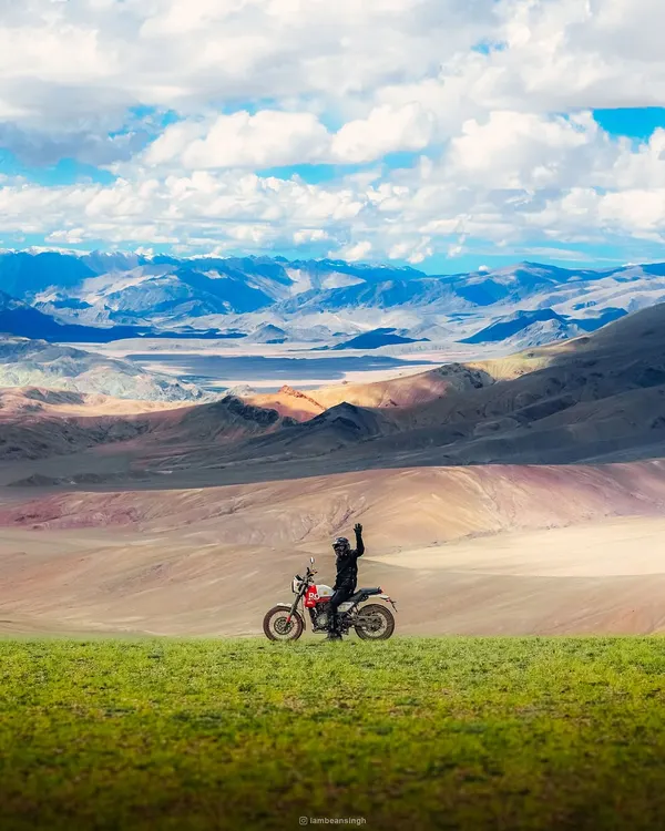 A biker pauses to take in the immense, multi-layered landscape of Ladakh. This shot is part of a series showcasing my self-taught journey and passion for capturing India's beauty.