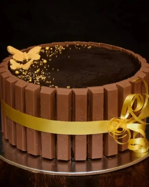 A classic and much-loved design. This chocolate truffle cake is wrapped with KitKat bars and tied with a beautiful gold ribbon. A simple gold butterfly adds a touch of elegance.