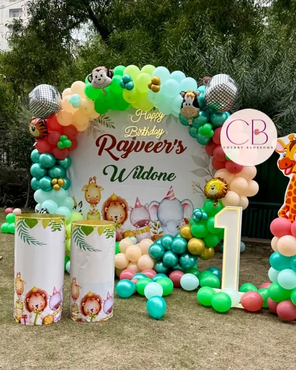 We transformed this outdoor lawn into a vibrant jungle for Rajveer's 'Wild One' first birthday party. This setup features a custom backdrop with a balloon arch, themed plinths, and character cutouts to create an immersive experience for the little guests.