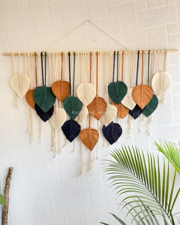 This custom leaf wall hanging was made with a beautiful earthy palette of forest green, navy, brown, and cream. You can choose the number of leaves and the exact colors to create a piece that feels like it was made just for your home.