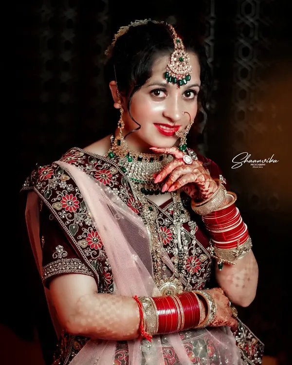A gorgeous bride showing off her intricate henna and jewelry. This bridal portrait focuses on the important details that make up the complete wedding look.
