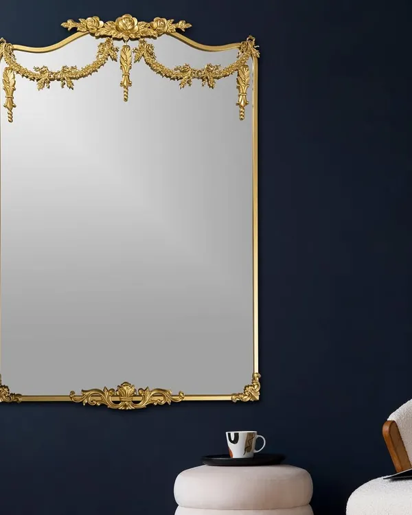This mirror is a masterpiece of classic design. The ornate, gilded frame with delicate garlands and flourishes makes it more than just a mirror; it's a piece of art that adds a touch of royal elegance to any room.