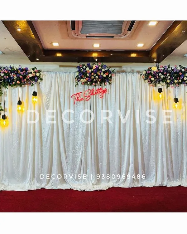 A custom neon sign is a great way to personalize your event. For this engagement, I created a sign with the family's surname, "The Shettys," which served as a central feature of the sparkling sequin backdrop.