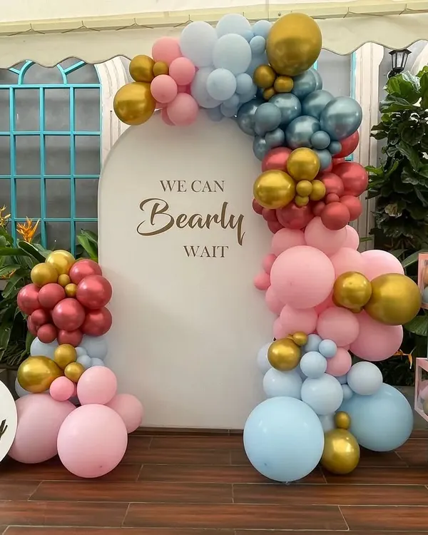 A beautiful "We Can Bearly Wait" baby shower theme with a gender-neutral color palette of pink, blue, and gold balloons.
