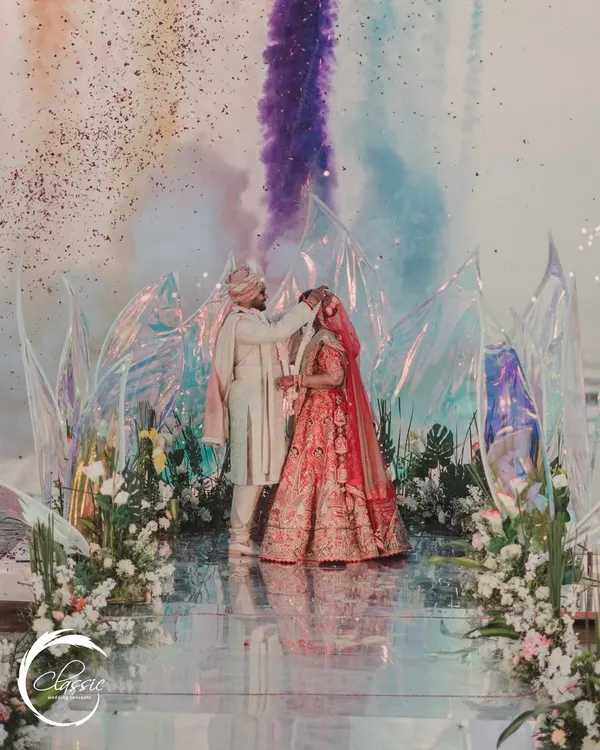 A truly unique Jaimala moment. I arranged for colored smoke to be released as the couple exchanged garlands, creating a vibrant, artistic, and unforgettable memory against the backdrop of the modern beach mandap.