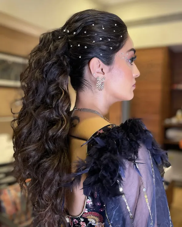 A glamorous ponytail for a sangeet night. I created voluminous curls and scattered delicate crystals throughout the hair for a touch of sparkle that catches the light with every movement.