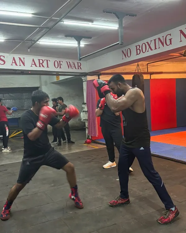 The intensity of our men's batch is on full display as two boxers engage in a controlled padwork drill. This is where technique is tested and refined under pressure, simulating real ring conditions.