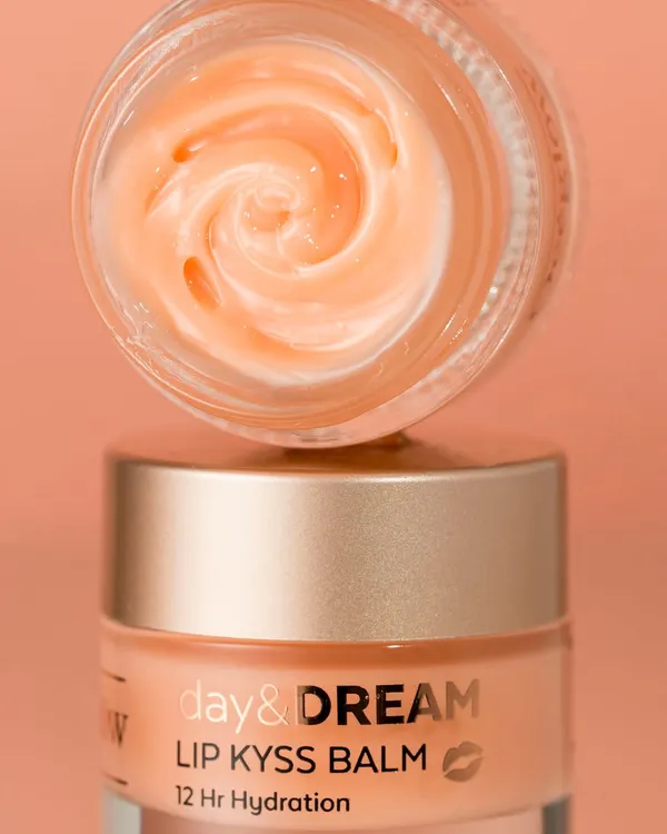 A close-up macro shot of a lip balm, revealing its whipped, creamy texture. The image is clean and focused, designed to make the product look appealing and luxurious. The lighting highlights the swirl in the balm, adding a sense of craftsmanship.