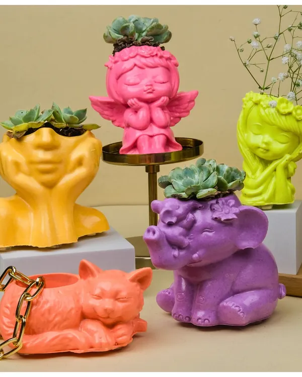 A colorful collection of my figurine-shaped Jesmonite planters. From sleepy cats to serene angels and elephants, these small pots are perfect for succulents and add a playful touch to your space.