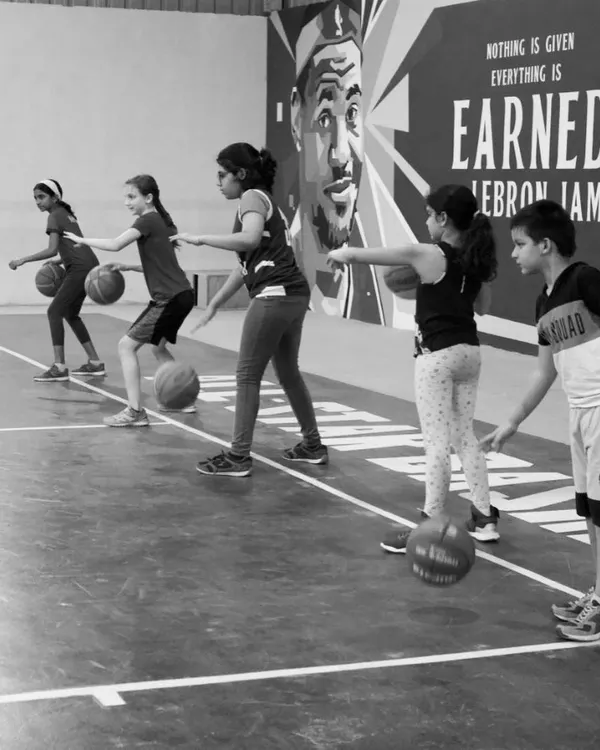 Our U10 and lil-hoops players lined up and focused. We start with the basics of ball handling, teaching them control and coordination in a fun, structured way.