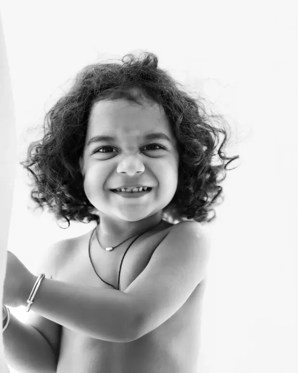 A mischievous and joyful grin captured in a stunning black and white close-up. This image is all about pure personality.