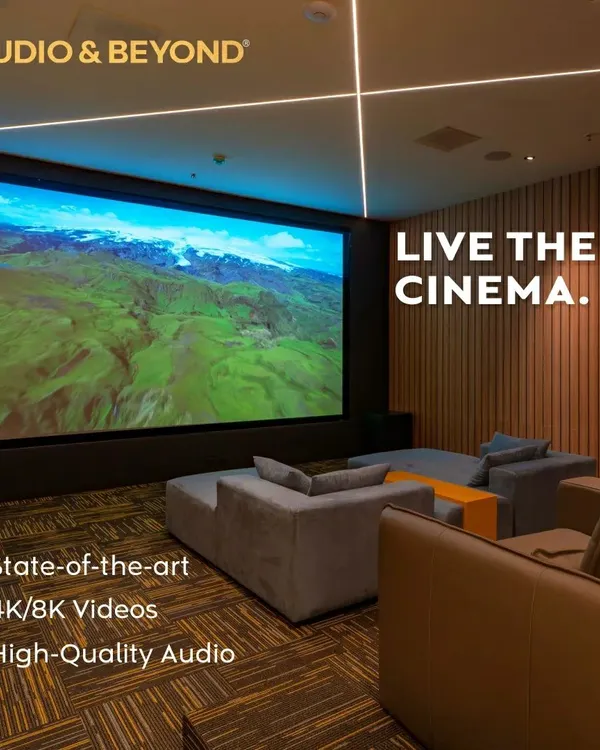 We believe in creating spaces where you can truly live the cinema. This modern media room features a massive 4K screen, plush, comfortable seating, and integrated ceiling lights, all designed to deliver a state-of-the-art, high-quality audio and video experience.