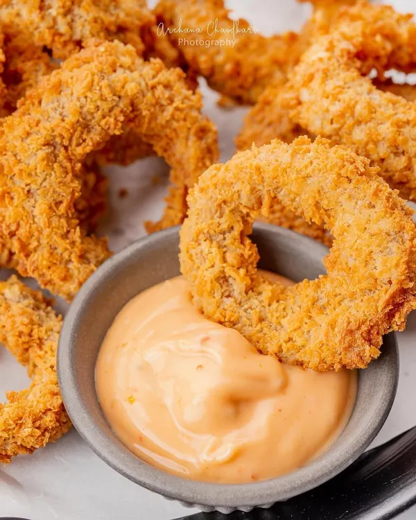 A classic appetizer, the onion ring, shot for The Bermuda Triangle. My focus here was on the crispy texture and golden color, making a simple dish look absolutely irresistible.