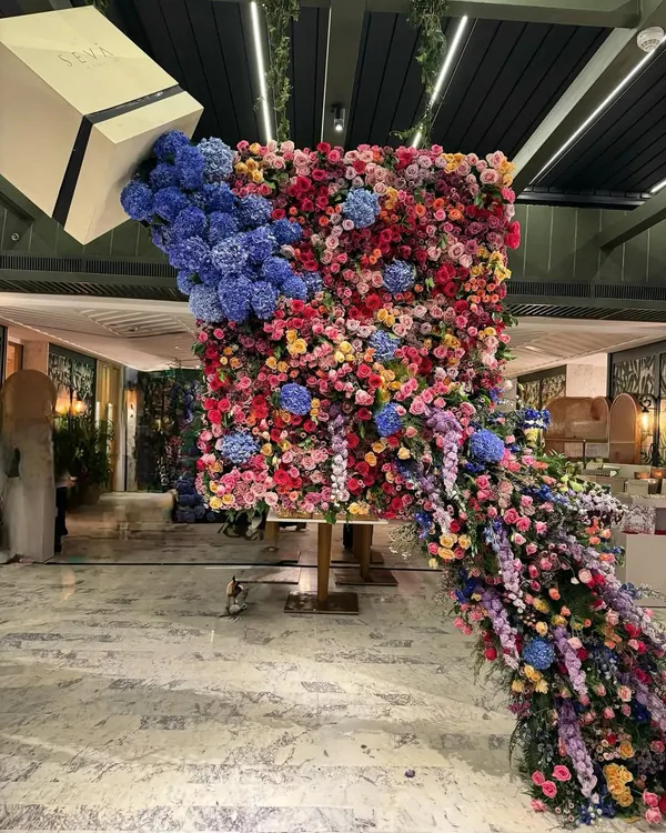 This is what I mean by floral drama. I created this overflowing floral sculpture for a product launch, designing it to feel like a continuous, abundant cascade of color and life. It's a perfect example of how I use flowers to create a bold, unforgettable statement.