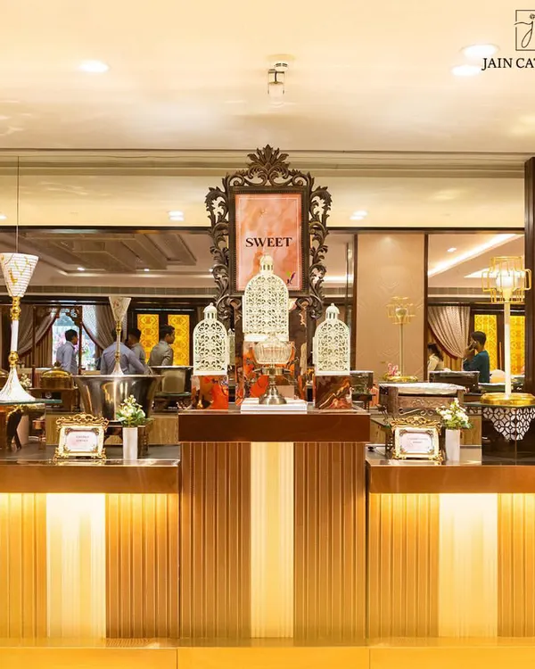 Turning your dessert dreams into a delectable reality. An elegant 'Sweet' station with ornate decor and a variety of beautifully arranged desserts.
