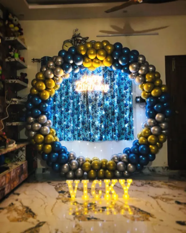 A full ring balloon decoration in blue, gold, and silver chrome, perfect for making a bold statement in a home setting.
