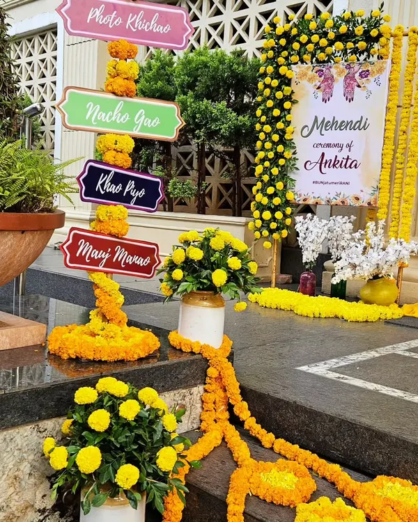 A classic Haldi and Mehendi entrance, bursting with the vibrant yellow of marigold flowers. We created fun, quirky signages like 'Photo Khichao' and 'Nacho Gao' to set a playful and celebratory mood right from the start.