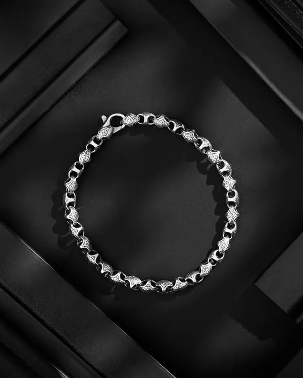 A striking shot of a diamond-studded bracelet from Orionz Jewels. We used geometric, textured panels to create a dynamic composition with strong lines and shadows, making the intricate details of the jewelry pop.