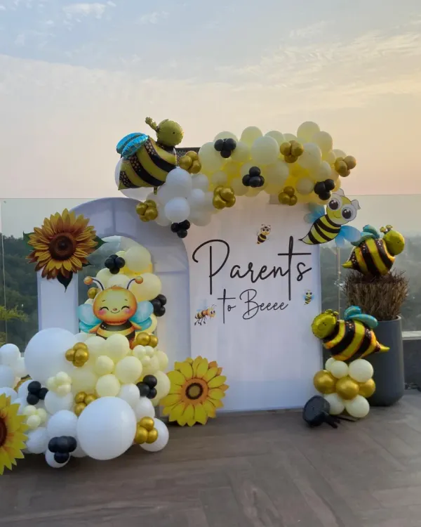 A sweet celebration for the "Parents to Bee." We designed this adorable bee-themed baby shower at a stunning rooftop location in Dehradun, complete with a custom backdrop, sunflower accents, and a yellow, white, and black balloon arrangement.