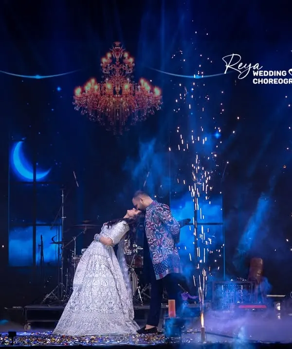 Dancing under the moonlight, lost in their own world. This shot captures the pure romance of a couple's performance. The dip, the pyrotechnics, the chemistry, it's a perfect filmy moment.