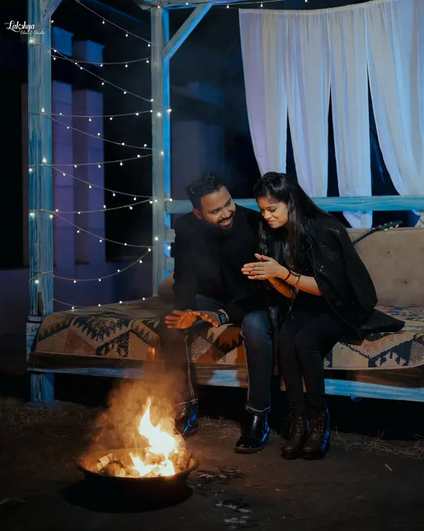 A cozy and romantic night shoot setup with a bonfire. This is a perfect example of how we can create a warm and intimate atmosphere in a studio setting.
