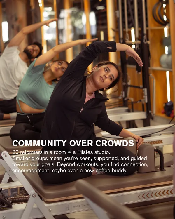 We prioritize community over crowds. Smaller groups mean I can give you the support and guidance you need to reach your goals. Here, a client gets a hands on assist during a stretch.