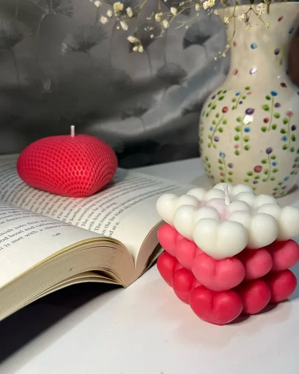 This cozy setup features two of our most loved designs. On the left is the textured heart candle from our Heart Collection, and on the right is the ombre heart bubble candle, both perfect for adding a touch of warmth and love to your favorite reading nook.