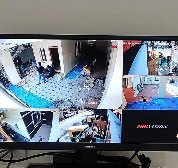 A live multi-view display from a Hikvision IP camera installation. You can see different angles of a property, including the entrance, hallways, and kitchen, all on one screen.