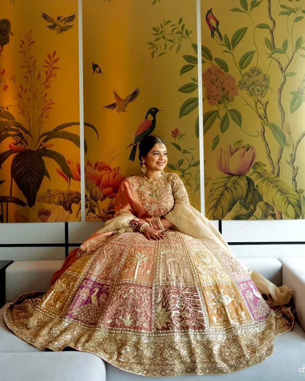 This is a look I created for my best friend, and it was pure magic. The pastel and gold lehenga paired with a soft, glowing makeup look against this stunning floral backdrop is what bridal dreams are made of.