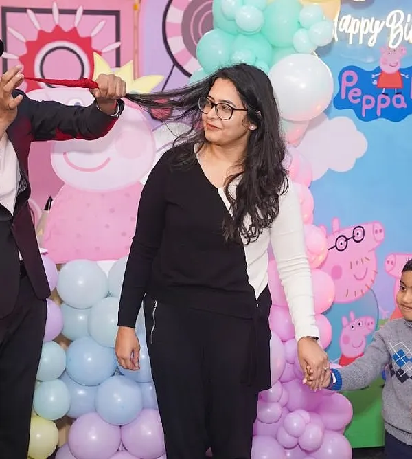 A magician captivates the audience with an interactive trick during a birthday party, creating a moment of wonder for both kids and parents.