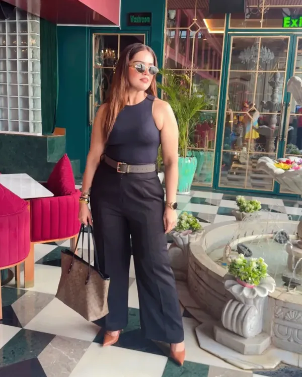 This is what I call power dressing. A sharp, all-black ensemble with a defined silhouette that's perfect for making a strong impression. This look combines a classic Zara top with Michael Kors and Coach accessories for effortless authority.