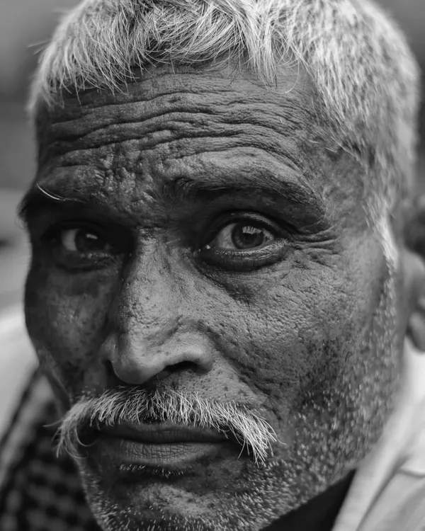 I believe a photograph can show more than what is on the surface. In this black and white portrait, the lines on this man's face in Bharatpur tell a story of a life lived, full of experiences that words cannot capture.