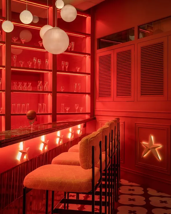 We designed this bar at Masala, New Delhi, to be an immersive experience. The vibrant red, custom star lights, and spherical pendants create a warm, celebratory atmosphere where every detail contributes to the narrative of the space.
