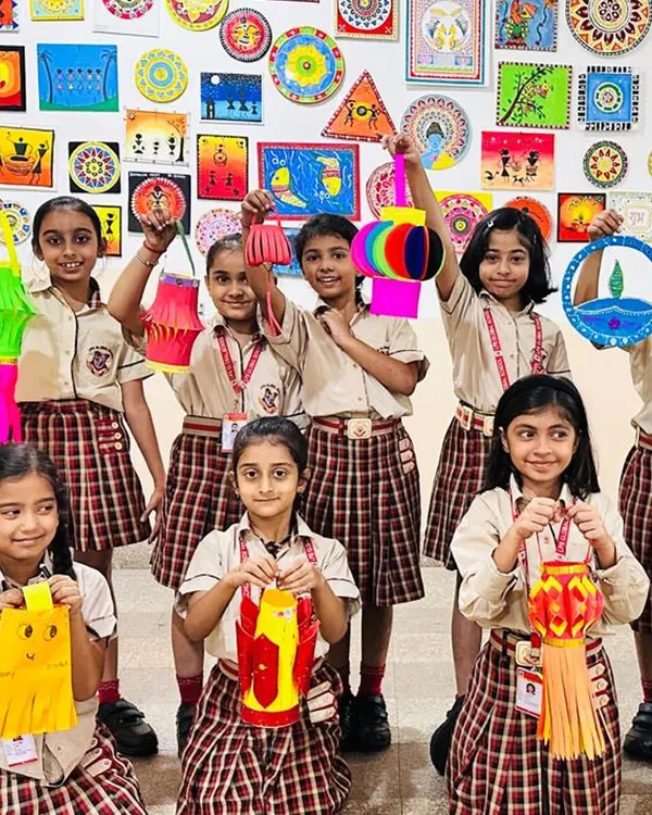 Our art sessions often incorporate cultural themes, such as this Diwali lantern-making workshop. Students proudly display their colorful creations, learning about festive traditions while honing their crafting skills.