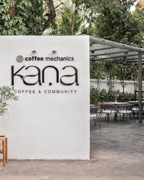 The entrance to Kana Cafe in Bangalore, a project conceived as an urban retreat. The design was inspired by breaking down barriers between the interior and exterior, allowing the serene, natural setting to become an integral part of the cafe experience.
