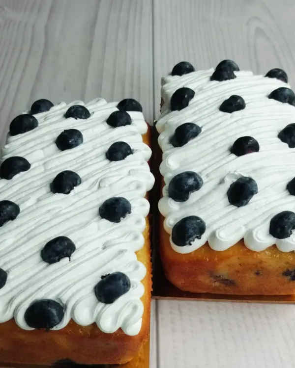 My Blueberry Tea Cake is a simple classic. The loaf is infused with fresh blueberries and topped with a light, airy whipped cream and more fresh berries.