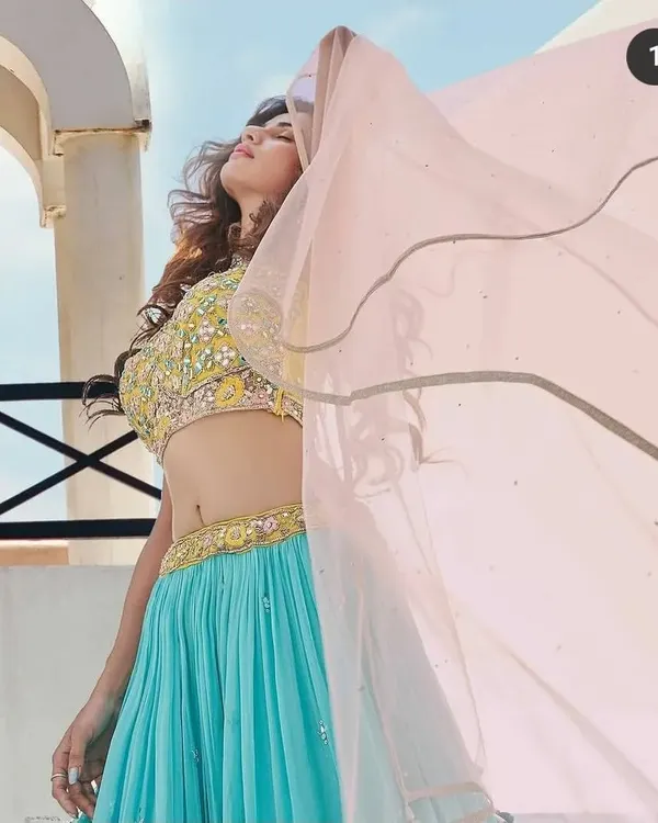My makeup is designed to look amazing in any light, especially outdoors. This shot from a pre-wedding shoot shows how the makeup stays fresh and vibrant under the sun. The flowing dupatta adds a dynamic feel, and the makeup complements the bright, happy mood perfectly.