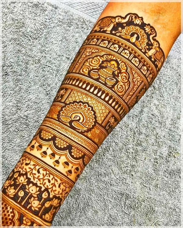 A detailed forearm band featuring traditional Indian motifs like the kalash (pot) and peacocks, perfect for any festive occasion.