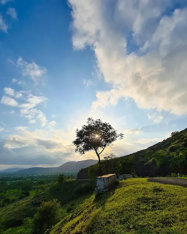 A moment of golden light breaking through the monsoon clouds. This shot captures the serene beauty of the countryside landscape in my hometown.